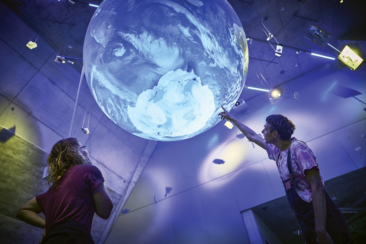 a globe shows data on climate and air traffic.