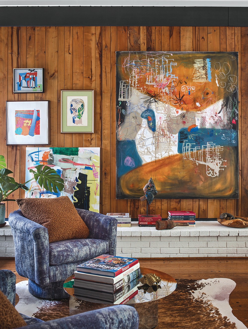 A close-up view of the living room designed by Jessica Davis shows how layering colorful artwork works