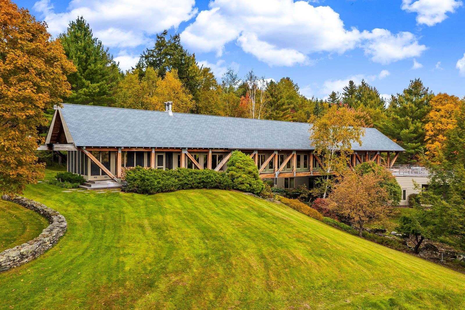 Deerwood is a contemporary masterpiece of architectural woodworking. Built to evoke Vermont’s covered bridges, it spans a narrow creek, and its glass walls reveal majestic mountain greenery. 